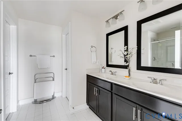 a bathroom with a double vanity sink and mirror