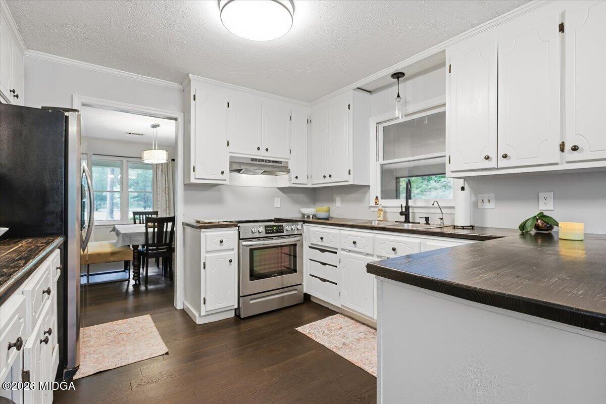 1608 Rumble Road Forsyth, GA 31029 - Photo 11 of 46 a kitchen with kitchen island granite countertop white cabinets and white appliances