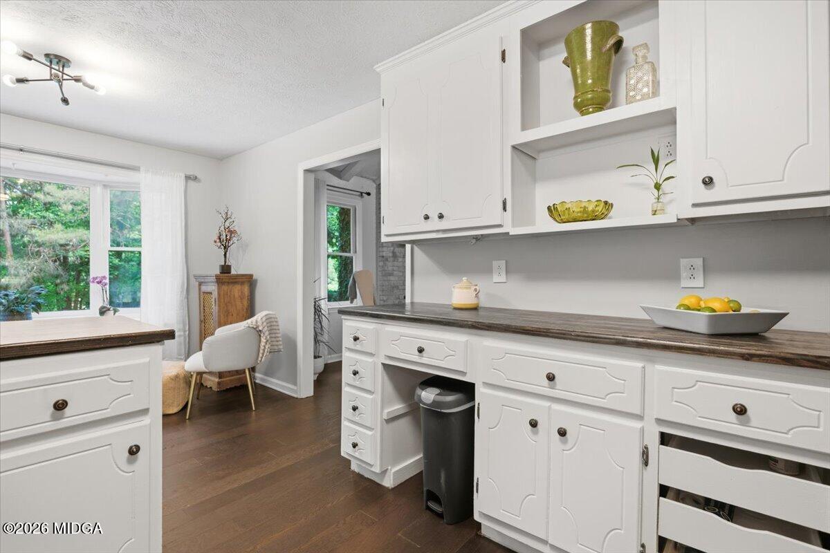 1608 Rumble Road Forsyth, GA 31029 - Photo 14 of 46 a kitchen with stainless steel appliances white cabinets and a wooden floor