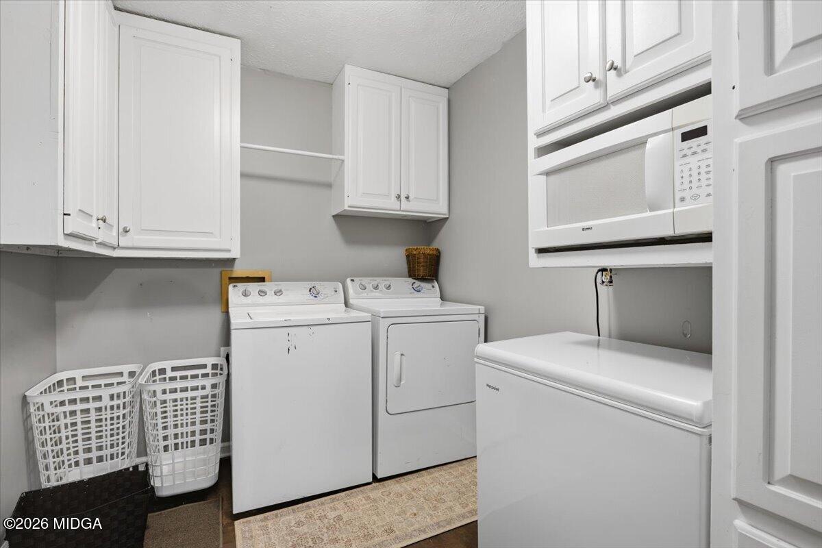 1608 Rumble Road Forsyth, GA 31029 - Photo 18 of 46 a utility room with dryer and washer