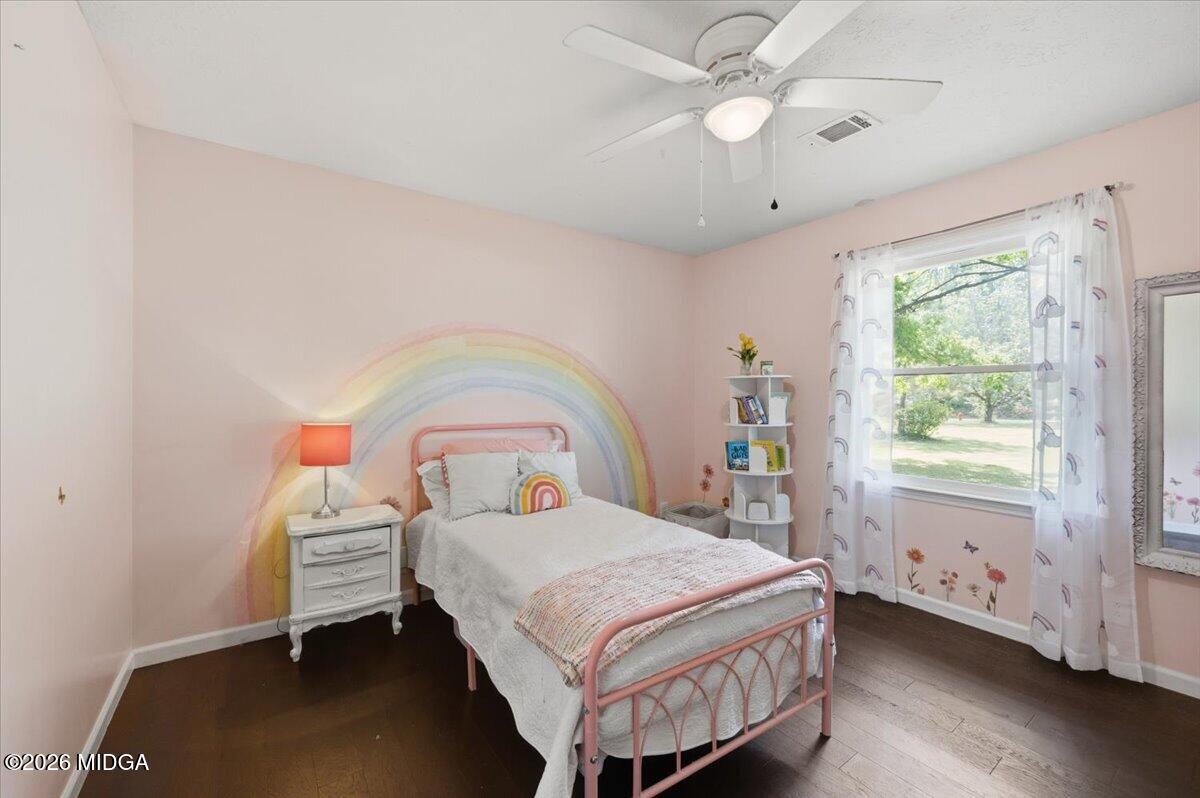 1608 Rumble Road Forsyth, GA 31029 - Photo 24 of 46 a bedroom with a bed and a chandelier