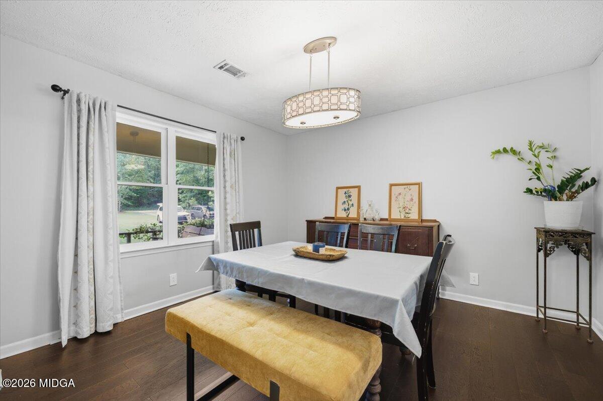 1608 Rumble Road Forsyth, GA 31029 - Photo 3 of 46 a view of a dining room with furniture window and wooden floor