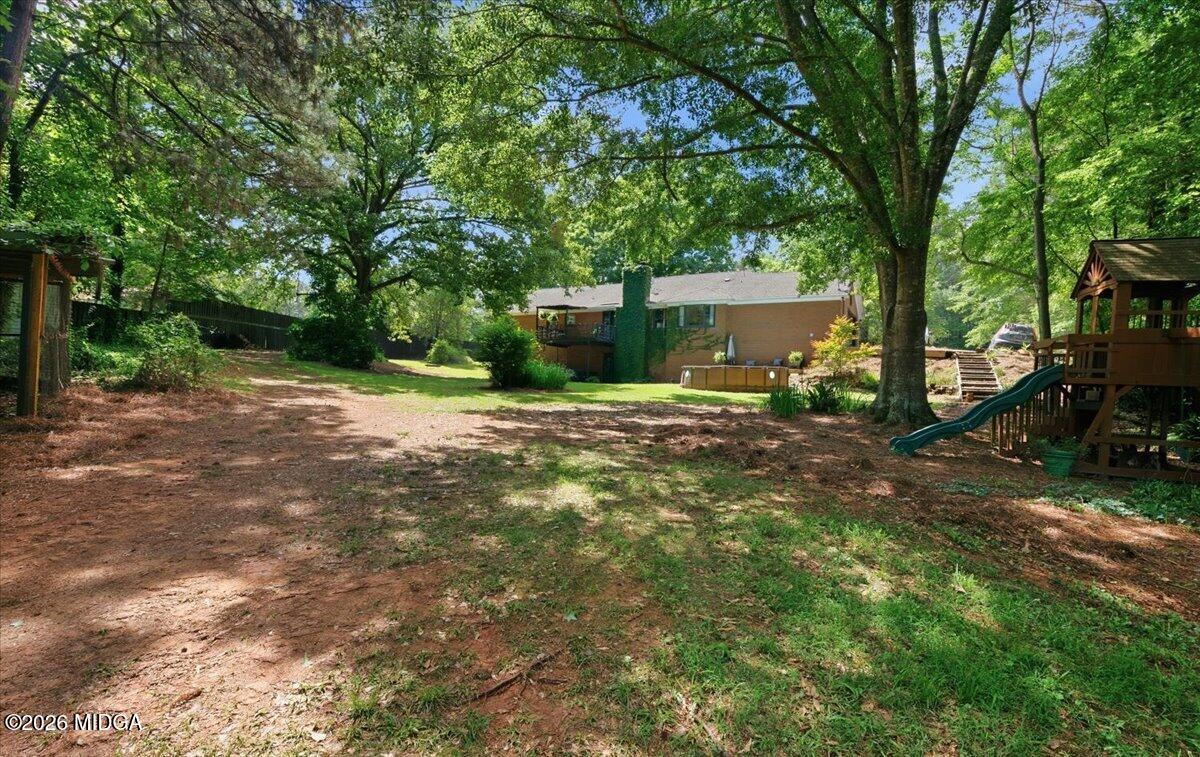 1608 Rumble Road Forsyth, GA 31029 - Photo 41 of 46 a backyard of a house with yard and trampoline