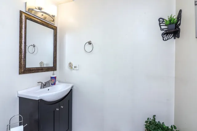 a bathroom with a sink vanity and a mirror