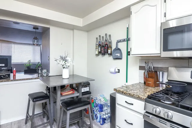 a kitchen with stainless steel appliances granite countertop a stove a sink and a refrigerator