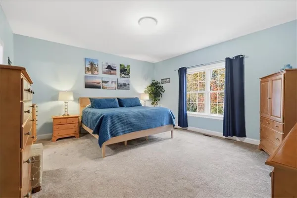 a bedroom with a bed and a night stand