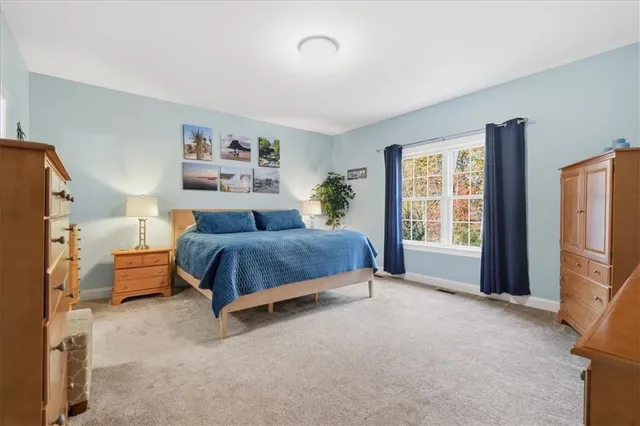 a bedroom with a bed and a night stand