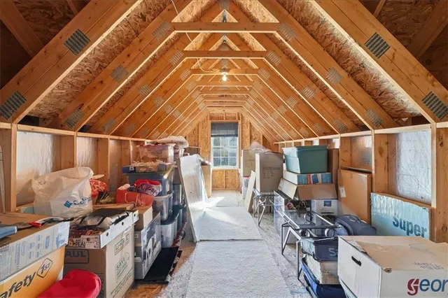 a view of kitchen with stainless steel appliances kitchen island microwave and cabinets
