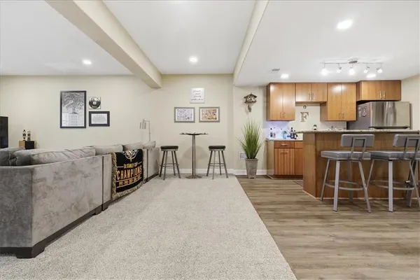 a view of a dining room with furniture kitchen and wooden floor