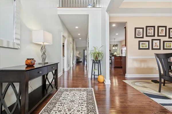 a view of a dining room with furniture and a chandelier