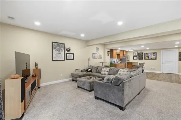 a view of a livingroom with wooden furniture and windows