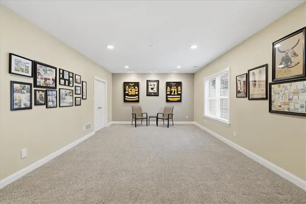 a view of a hallway with bathroom and a mirror