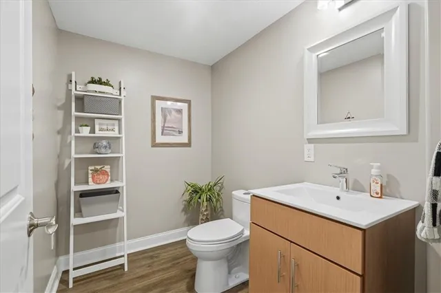 a front view of a house with a garden and a tree