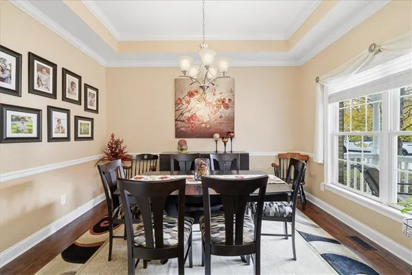 a view of a dining room with furniture window and wooden floor
