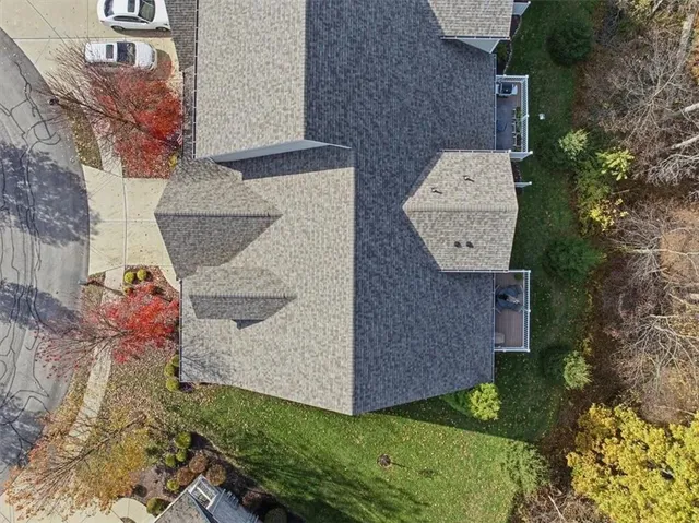 an aerial view of a house with a yard