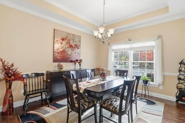 a kitchen with stainless steel appliances granite countertop a stove top oven a sink a stove a dining table and chairs