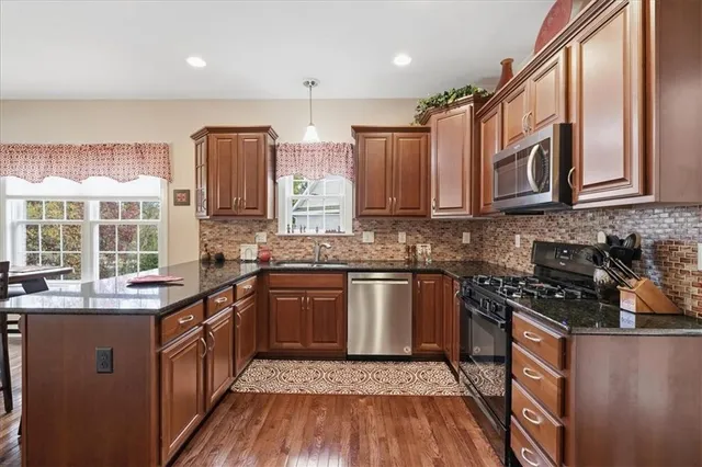 a kitchen with granite countertop a sink and cabinets