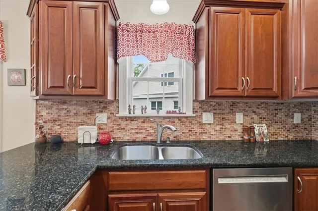 a kitchen with granite countertop a stove microwave and cabinets