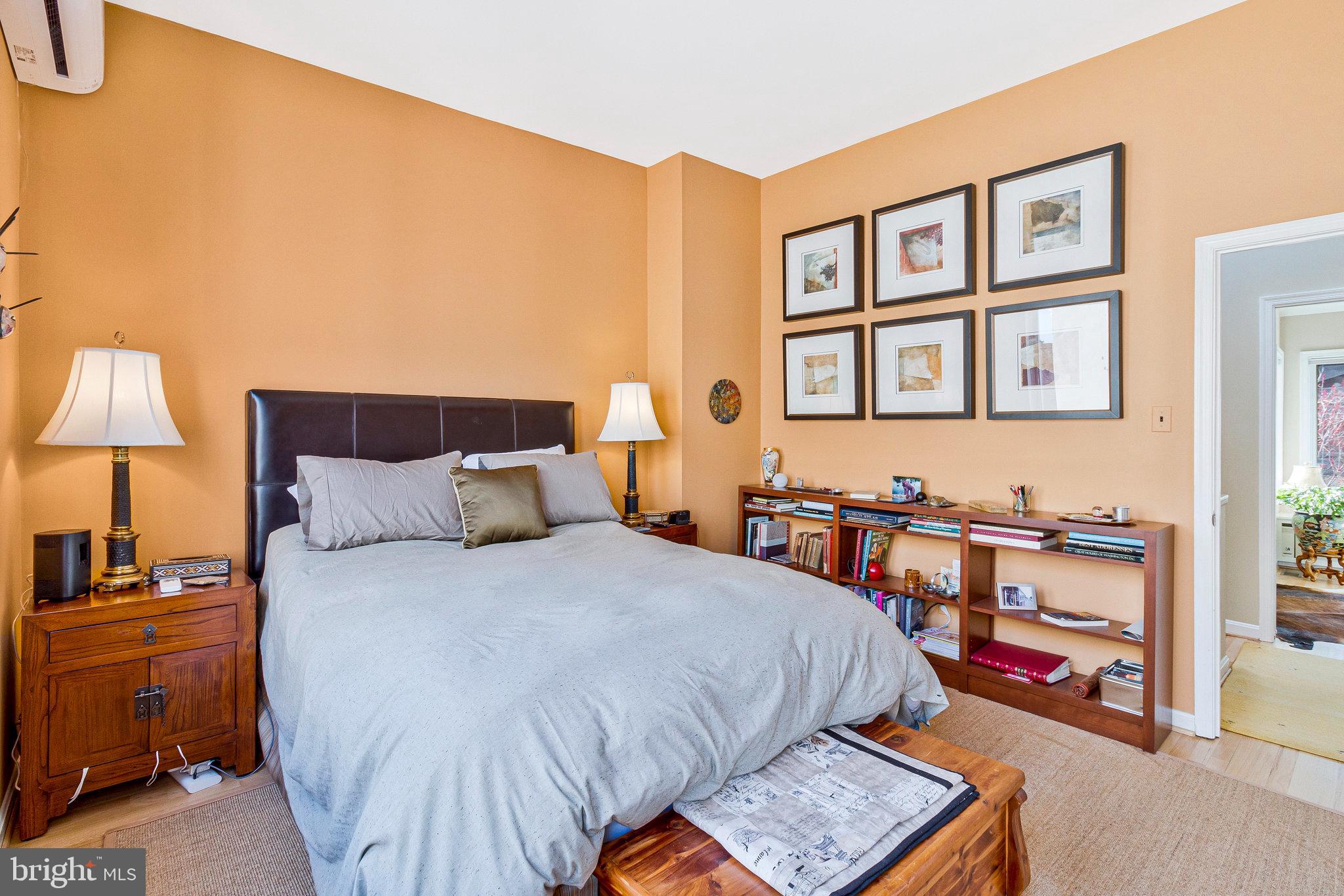 1501 Church Street Northwest Washington, DC 20005 - Photo 19 of 51 a bedroom with a bed a dresser and painting on the wall