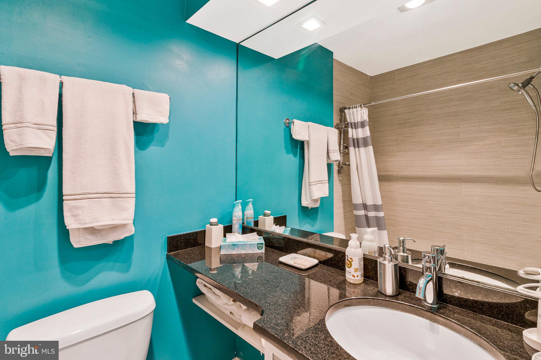 1501 Church Street Northwest Washington, DC 20005 - Photo 42 of 51 a bathroom with a granite countertop sink and a mirror