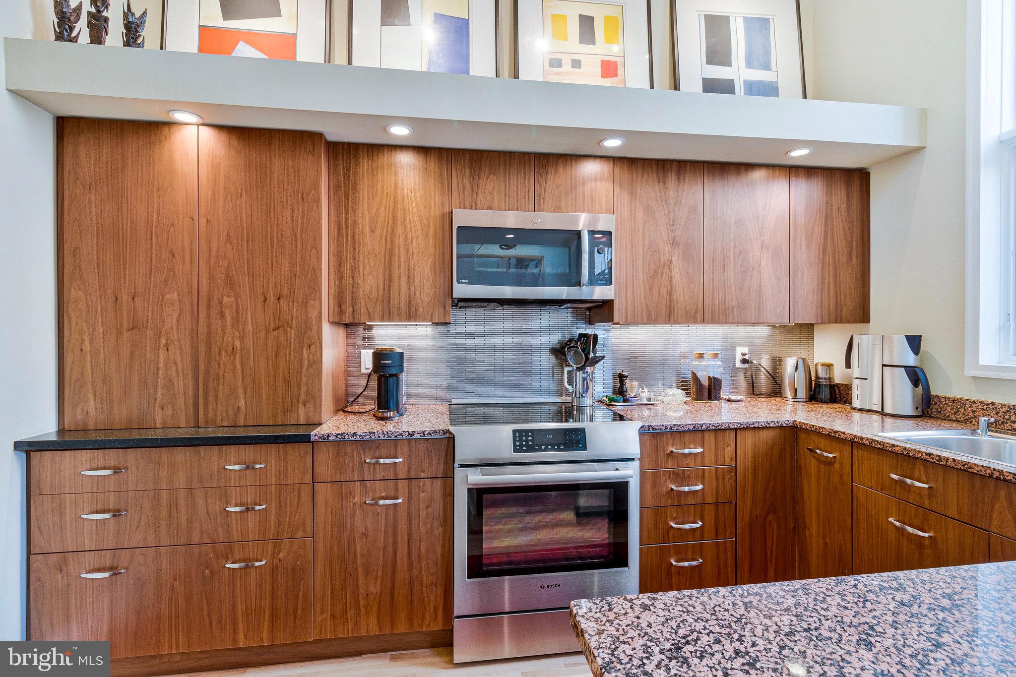 1501 Church Street Northwest Washington, DC 20005 - Photo 7 of 51 a kitchen with granite countertop wooden cabinets and stainless steel appliances