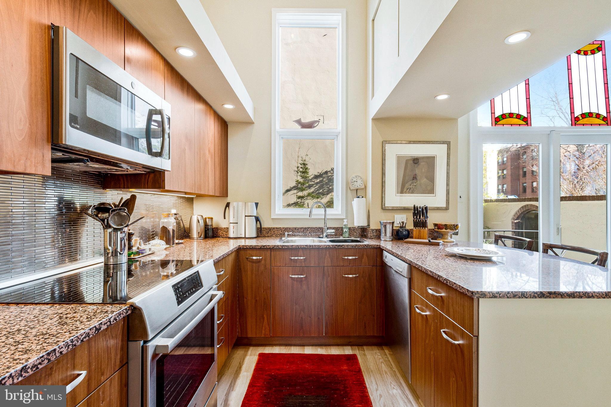 1501 Church Street Northwest Washington, DC 20005 - Photo 8 of 51 a kitchen with a sink stove and cabinets