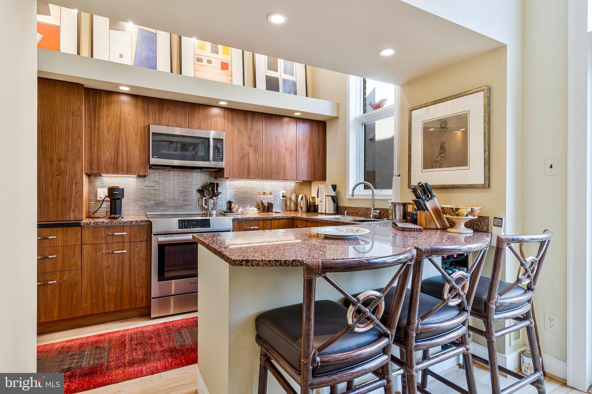 1501 Church Street Northwest Washington, DC 20005 - Photo 9 of 51 a kitchen with a table chairs and cabinets