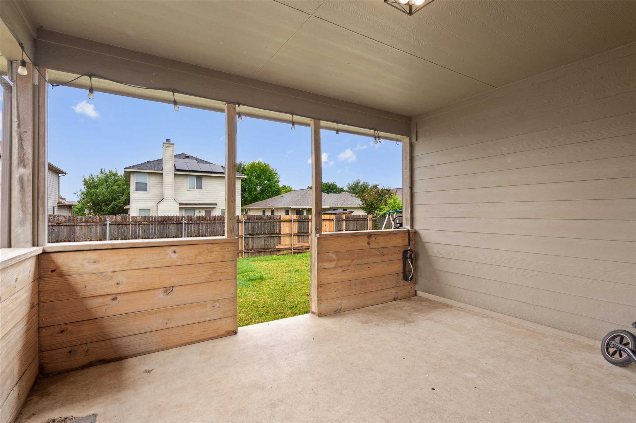 606 Old Peak Road Georgetown, TX 78626 - Photo 16 of 23 Covered patio with a concrete floor, horizontal wood paneling, and an overhead light fixture