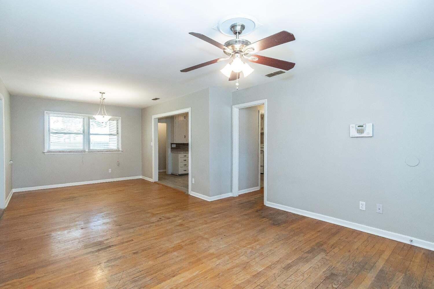 4212 42nd Street Lubbock, TX 79413 - Photo 4 of 18 wooden floor in an empty room with a window