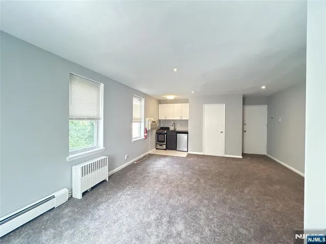 a view of a livingroom with a window and furniture