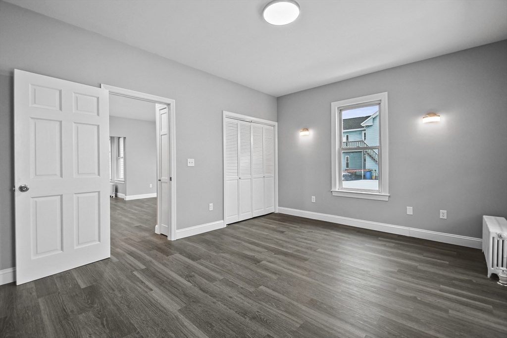 509 High Street Clinton, MA 01510 - Photo 11 of 42 an empty room with wooden floor and windows