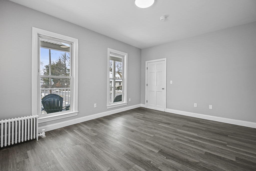 509 High Street Clinton, MA 01510 - Photo 13 of 42 a view of an empty room with wooden floor and a window