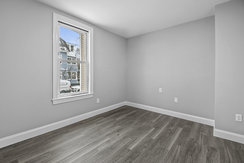 509 High Street Clinton, MA 01510 - Photo 14 of 42 wooden floor in an empty room with a window