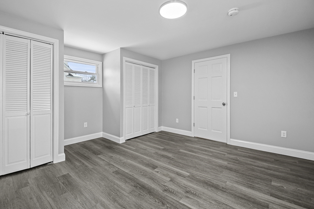 509 High Street Clinton, MA 01510 - Photo 19 of 42 a view of an empty room with wooden floor and a window