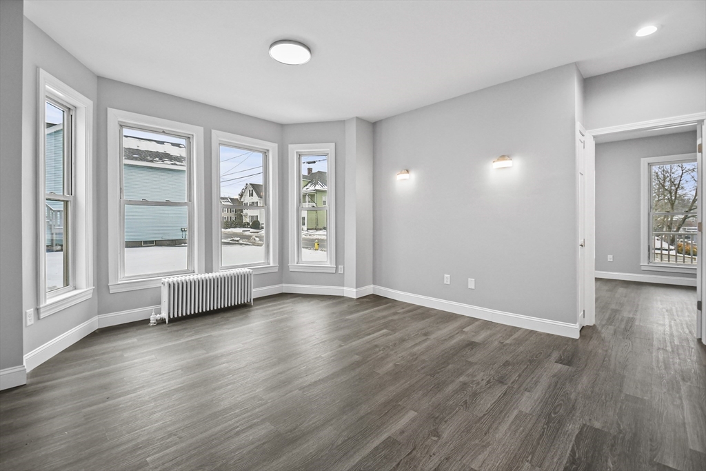 509 High Street Clinton, MA 01510 - Photo 2 of 42 an empty room with wooden floor and windows