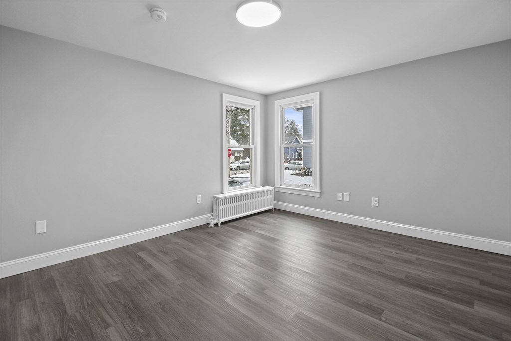 509 High Street Clinton, MA 01510 - Photo 21 of 42 a view of an empty room with wooden floor and a window
