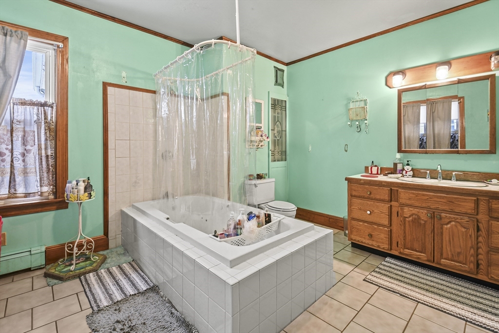 509 High Street Clinton, MA 01510 - Photo 33 of 42 a bathroom with a tub sink and mirror