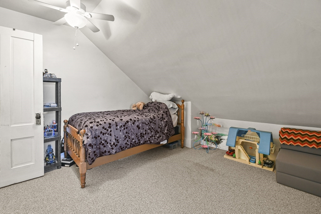 509 High Street Clinton, MA 01510 - Photo 34 of 42 a bedroom with a bed and a chandelier