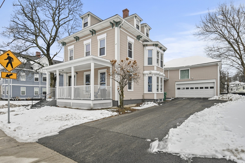 509 High Street Clinton, MA 01510 - Photo 39 of 42 a front view of a house with a yard and garage