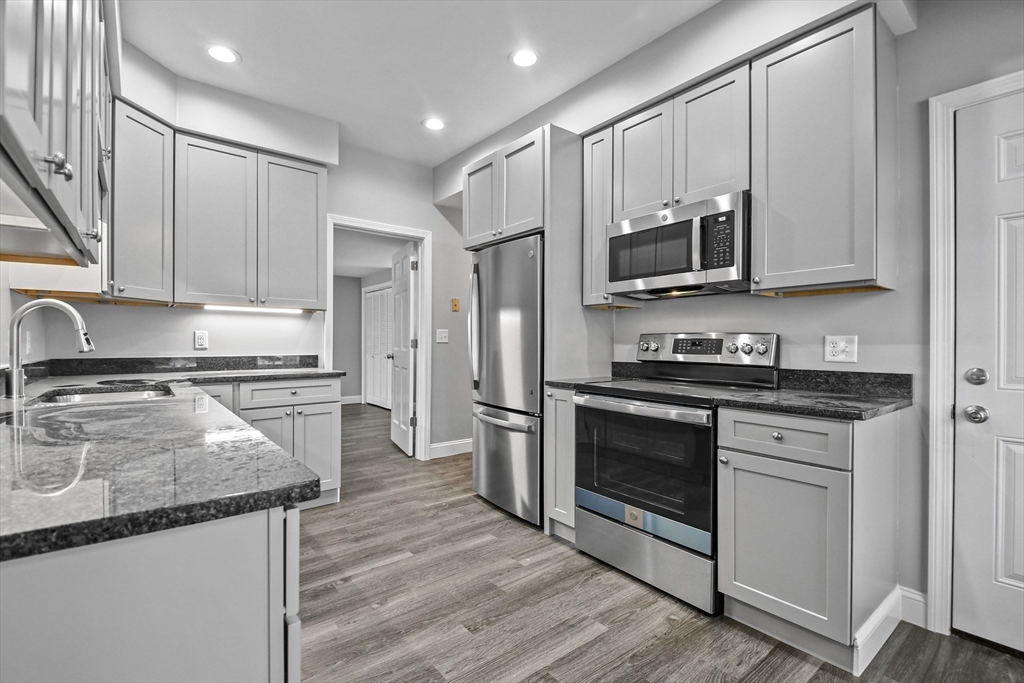 509 High Street Clinton, MA 01510 - Photo 5 of 42 a kitchen with stainless steel appliances granite countertop a stove a sink and a refrigerator