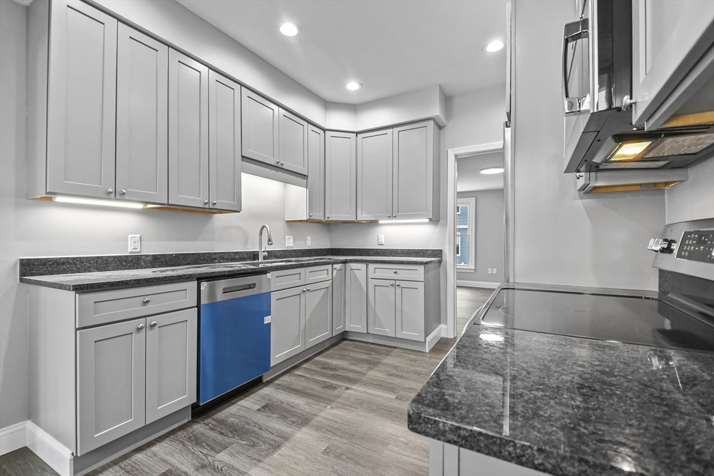 509 High Street Clinton, MA 01510 - Photo 6 of 42 a kitchen with granite countertop a sink stainless steel appliances and cabinets