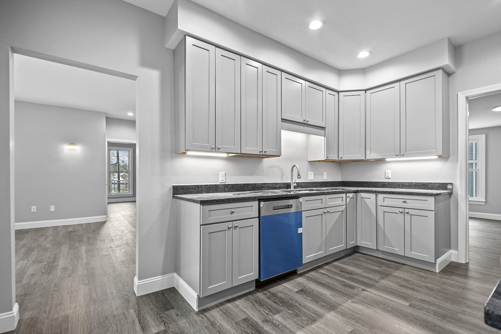 509 High Street Clinton, MA 01510 - Photo 7 of 42 a kitchen with granite countertop white cabinets and stainless steel appliances