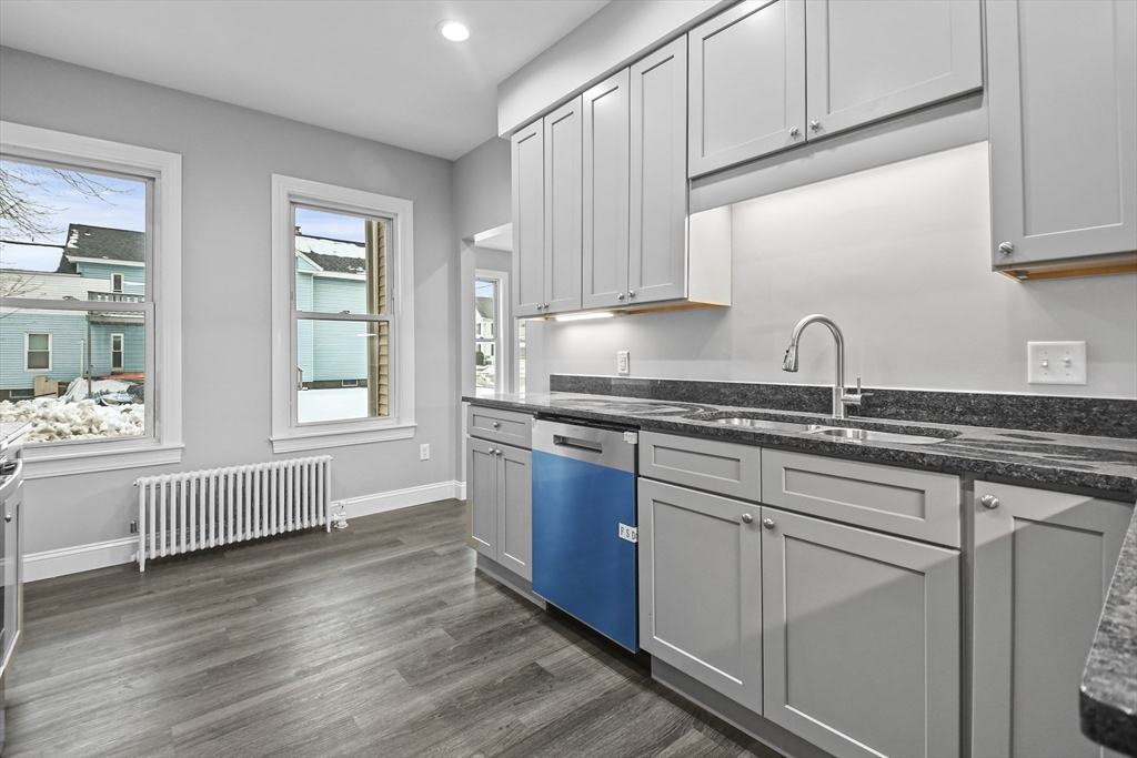 509 High Street Clinton, MA 01510 - Photo 8 of 42 a kitchen with granite countertop white cabinets and white appliances
