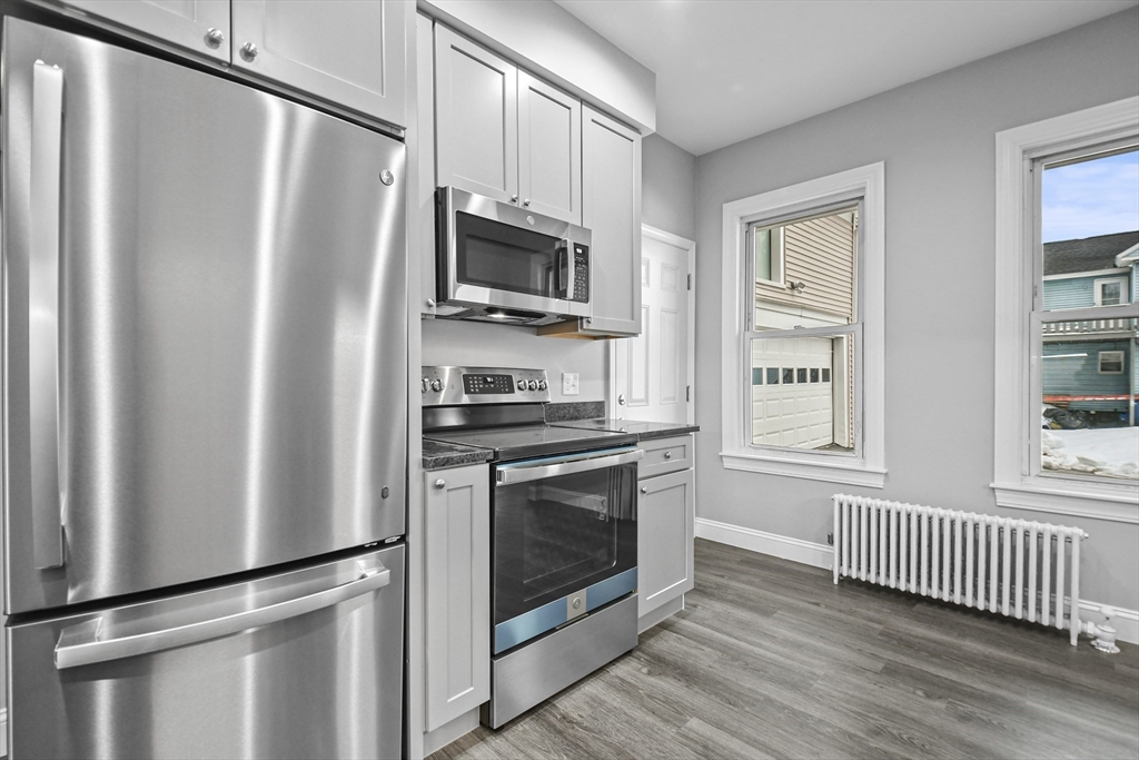 509 High Street Clinton, MA 01510 - Photo 9 of 42 a kitchen with stainless steel appliances a refrigerator sink and microwave
