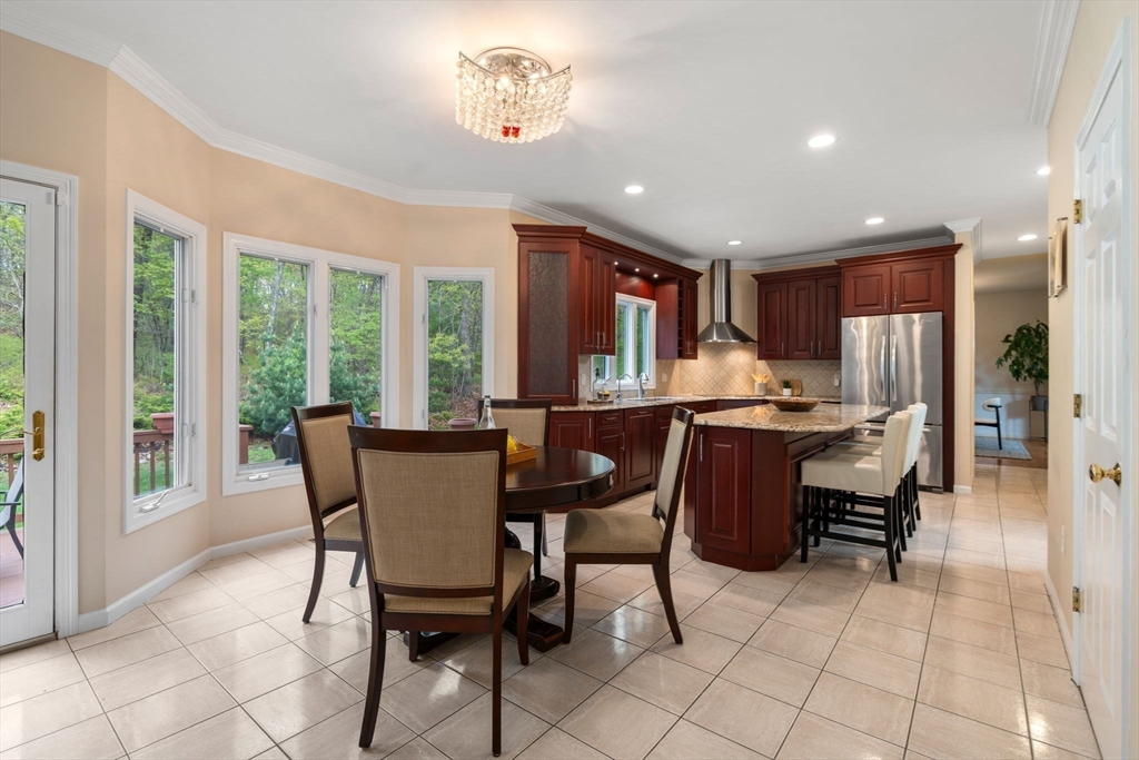 11 Black Elk Road Sharon, MA 02067 - Photo 10 of 28 a dining room with furniture a chandelier and window