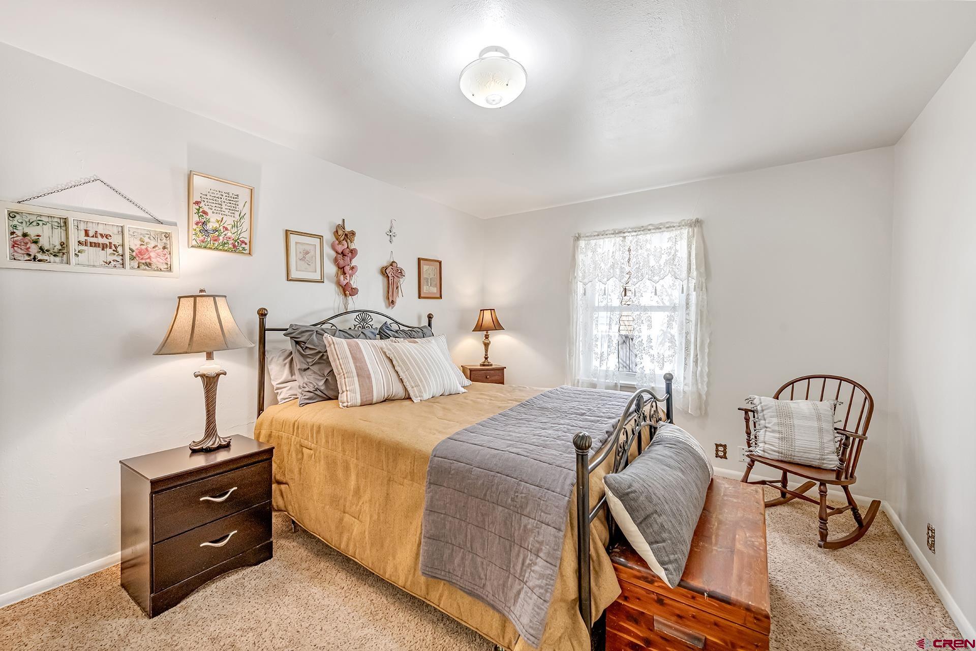 735 Howard Street Delta, CO 81416 - Photo 17 of 34 a bedroom with a bed and a chair