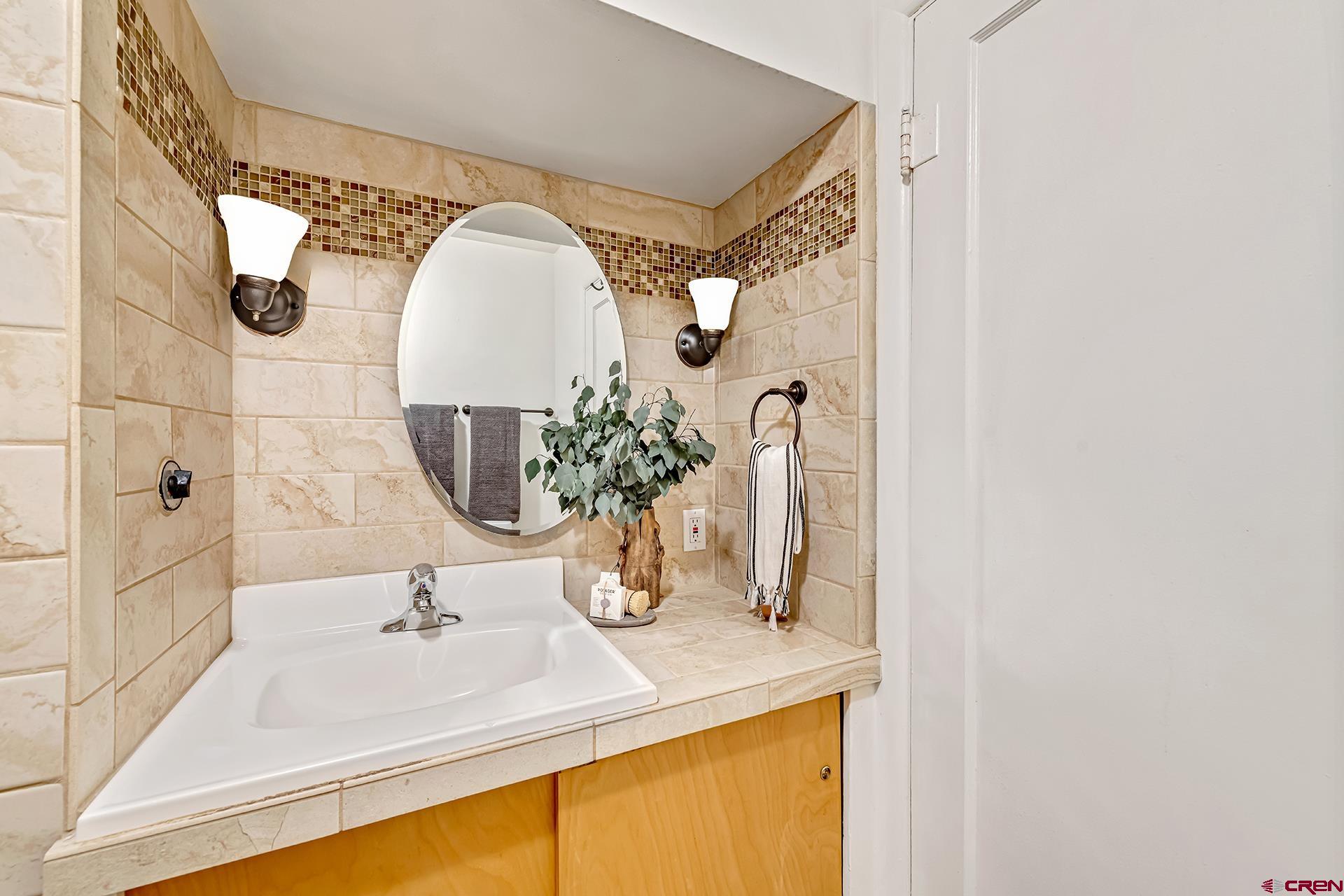 735 Howard Street Delta, CO 81416 - Photo 19 of 34 a bathroom with a sink and a mirror