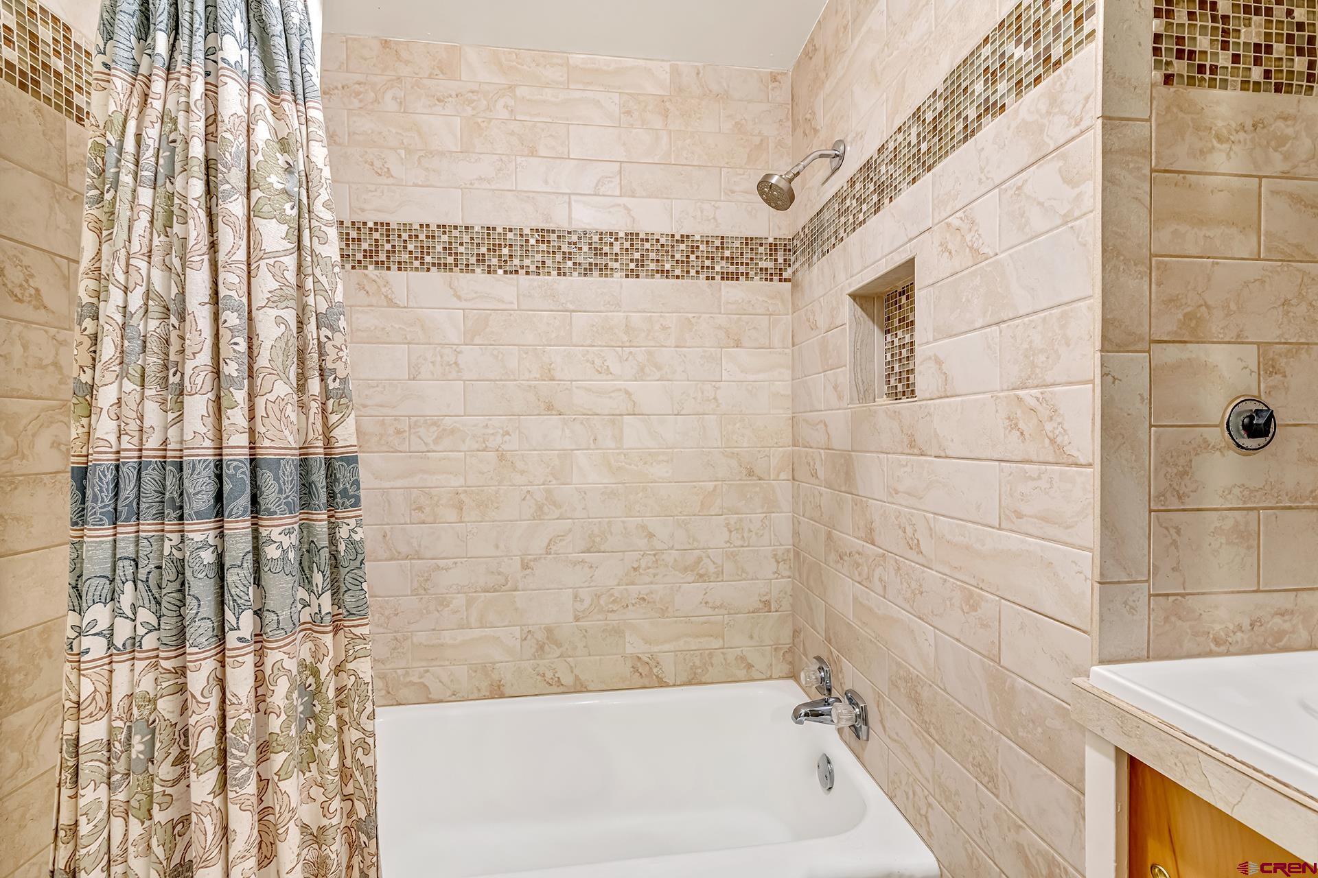 735 Howard Street Delta, CO 81416 - Photo 20 of 34 a bath tub sitting next to a white sink