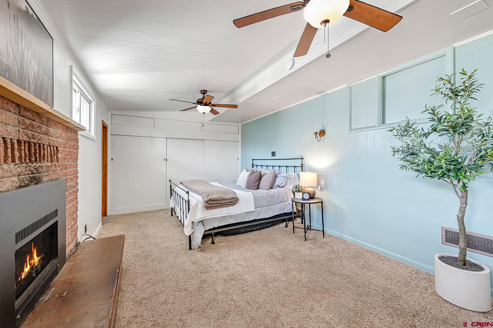 735 Howard Street Delta, CO 81416 - Photo 23 of 34 a bedroom with furniture and a fireplace
