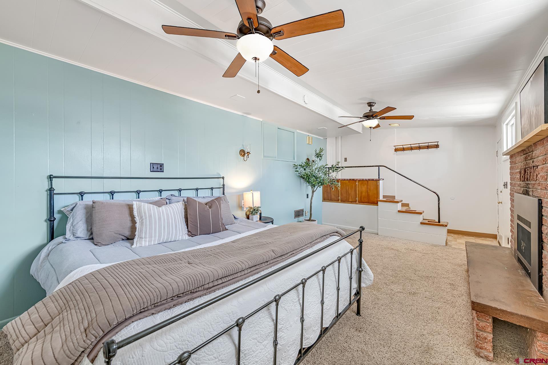 735 Howard Street Delta, CO 81416 - Photo 25 of 34 a bedroom with a bed and a chandelier